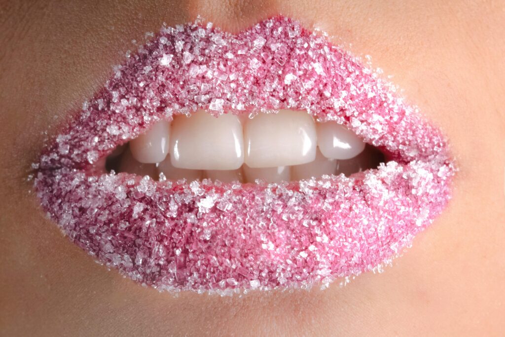 pexels-photo-925802-925802-1 Artistic close-up of lips coated with pink sugar crystals, showcasing beauty and creativity.
